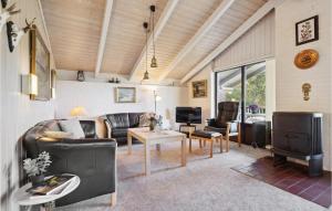 a living room with leather couches and a tv at Awesome Home In Henne With 3 Bedrooms And Sauna in Henne Strand