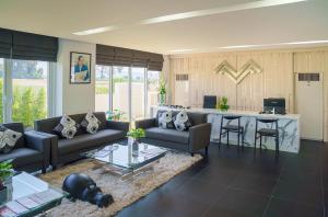 a living room with a couch and a table at Mirage Condominium in Sattahip