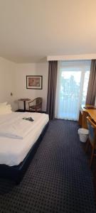 a hotel room with a bed and a window at Aparthotel Höper in Oyten