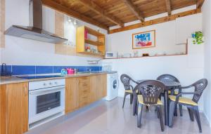a kitchen with a table and chairs in a room at Gorgeous Apartment In Las Palmas With Wifi in Las Playitas