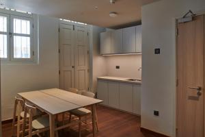 a kitchen and dining room with a table and chairs at KINN Studios in Singapore