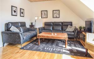 a living room with two leather couches and a coffee table at Beautiful Apartment In Blvand With 1 Bedrooms in Blåvand