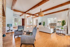 a living room with a white couch and chairs at VACATION MARBELLA I Villa Ballesteros, Near Golf Courses, Private Pool and Gigantic Garden in Estepona