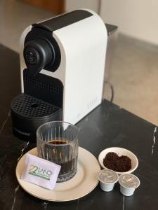 a coffee maker sitting on a counter with a cup of coffee at 22Land Hotel & Residence in Hanoi