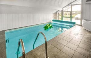 a swimming pool in a house with a pool at Nice Home In Thisted With 5 Bedrooms, Sauna And Wifi in Klitmøller