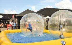 a young boy is in two bubble balls in a pool at Klitten in Søndervig