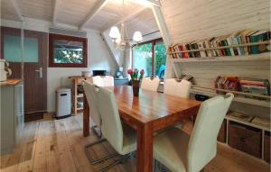 a dining room with a wooden table and chairs at Stunning Home In Rekem-lanaken With Wifi in Bovenwezet