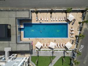 an overhead view of a swimming pool with lounge chairs at Грейс Аква Вилла in Sukhum