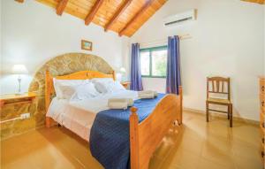 a bedroom with a large bed and a chair at Lovely Home In Partanna With Wifi in Partanna