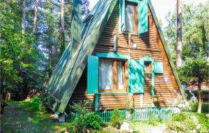 a house with a gambrel roof and green windows at Nice Home In Mragowo With 2 Bedrooms in Kosewo