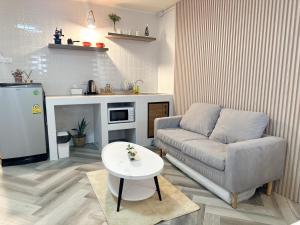 a living room with a couch and a table at NK hostel 31 in Ban Bang Phang