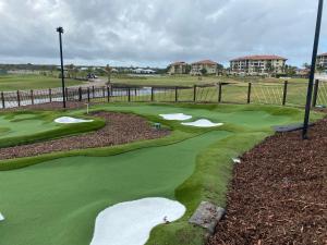 a golf course with several holes and a green at Pelican Waters Resort One Bedroom Apartment in Pelican Waters