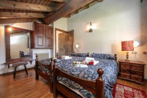 a bedroom with a bed and a table and a desk at Arianna - Happy Rentals in Livigno