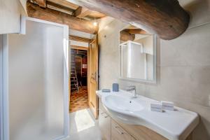 a bathroom with a sink and a mirror at Arianna - Happy Rentals in Livigno