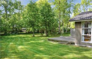 a yard with a porch and a house at Holiday Home Villesensvej Ii in Fjellerup