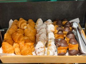 a tray of different types of breads and pastries at SM Hotel Sant Antoni in Barcelona