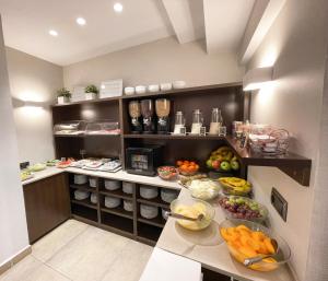 a kitchen with fruits and vegetables on a counter at SM Hotel Sant Antoni in Barcelona