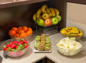 a counter topped with bowls of fruit and vegetables at SM Hotel Sant Antoni in Barcelona