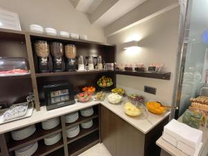 a kitchen with a counter with plates and food at SM Hotel Sant Antoni in Barcelona