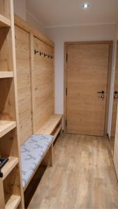 a room with wooden shelves and a door at Bucherwirt Appartements in Buch bei Jenbach