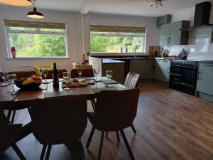 a kitchen and dining room with a table and chairs at Beech House in Fort William