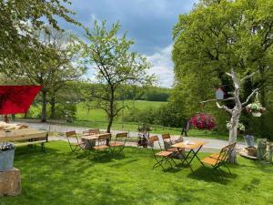 a group of tables and chairs in the grass at Bauerngarten in Hofgeismar