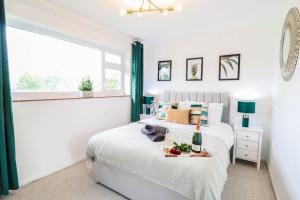 a white bedroom with a bed and a window at Ted House - Long Stay Discount in Royal Tunbridge Wells