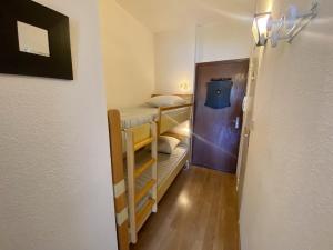 a small room with bunk beds and a hallway at Studio Les Angles, 1 pièce, 4 personnes - FR-1-758-4 in Les Angles