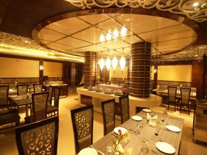 a dining room with tables and chairs in a restaurant at Hotel Costa River in Varanasi