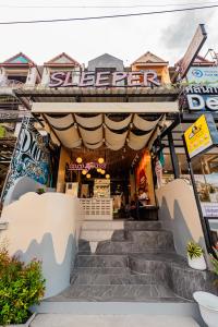a building with stairs in front of it at Sleeper Hostel in Ao Nang Beach