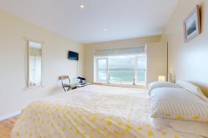 Un dormitorio con una cama grande con vista al mar. en Superb Panoramic Sea Views Sleeps 10 Pet Friendly, en Woolacombe