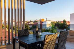 een zwarte tafel en stoelen op een balkon met uitzicht bij Apartment Dalmo Views in Zadar
