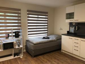 a small bedroom with a bed and a microwave at GottwaldHaus-Freiberg-Apartment / B in Freiberg