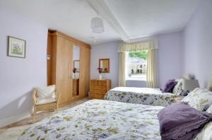 a bedroom with two beds and a window at 2 bed rural retreat nestled in the heart of Exmoor in Parracombe