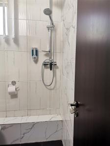 uma casa de banho com um chuveiro e um telefone na parede em Apartament Sonya em Bucareste