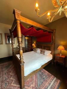 a bedroom with a canopy bed and a rug at Golden Fleece York in York