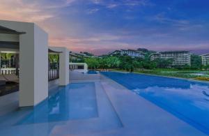a view of a swimming pool in a house at Pico De Loro 2BR Carola B Unit with Lagoon View in Nasugbu