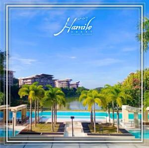 a picture of a pool with palm trees and buildings at Pico De Loro 2BR Carola B Unit with Lagoon View in Nasugbu