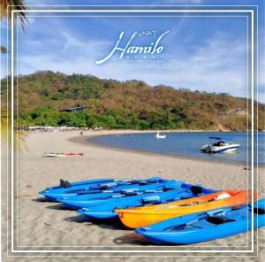 a group of boats lined up on a beach at Pico De Loro 2BR Carola B Unit with Lagoon View in Nasugbu