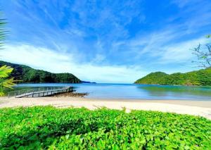 a view of a beach with a pier at Pico De Loro 2BR Carola B Unit with Lagoon View in Nasugbu