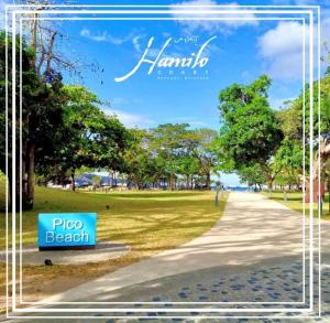 a path in a park with a sign that reads pizza beach at Pico De Loro 2BR Carola B Unit with Lagoon View in Nasugbu