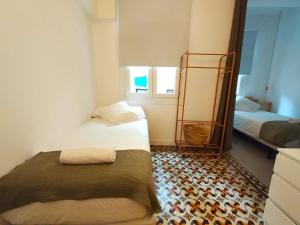 a small room with two beds and a mirror at VibesCoruña- Apartamento céntrico recién reformado in A Coruña