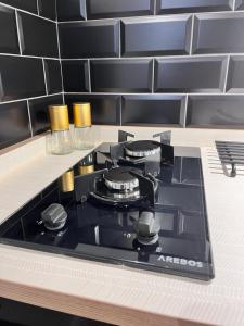 a black stove top oven in a kitchen at The Boot Room Ground Floor Studio Apartment in Burnham-on-Crouch