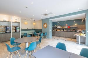 a restaurant with tables and chairs and a counter at Les Loges du Park - Résidence hôtelière in Aix-les-Bains