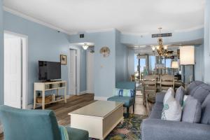 a living room with a couch and a dining room at Surfside Resort #309 in Destin