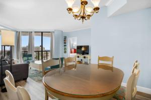 a dining room with a table and chairs and a couch at Surfside Resort #309 in Destin