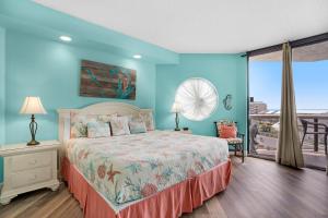 a blue bedroom with a bed and a balcony at Surfside Resort #309 in Destin +50 photos