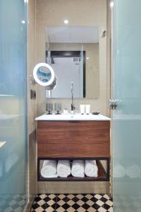 a bathroom with a sink and a mirror at Hotel Cortes Rambla in Barcelona