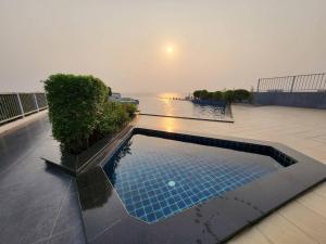 a swimming pool on the roof of a building at The patio condo Bang saen in Ban Bang Saen (1)