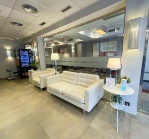 a lobby with white couches and a table at SM Hotel Sant Antoni in Barcelona